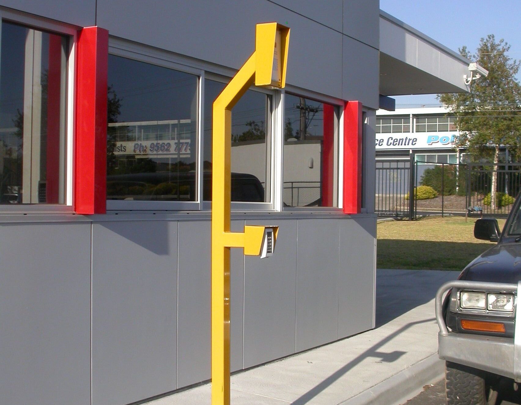 Retractable bollards in vehicle access lane